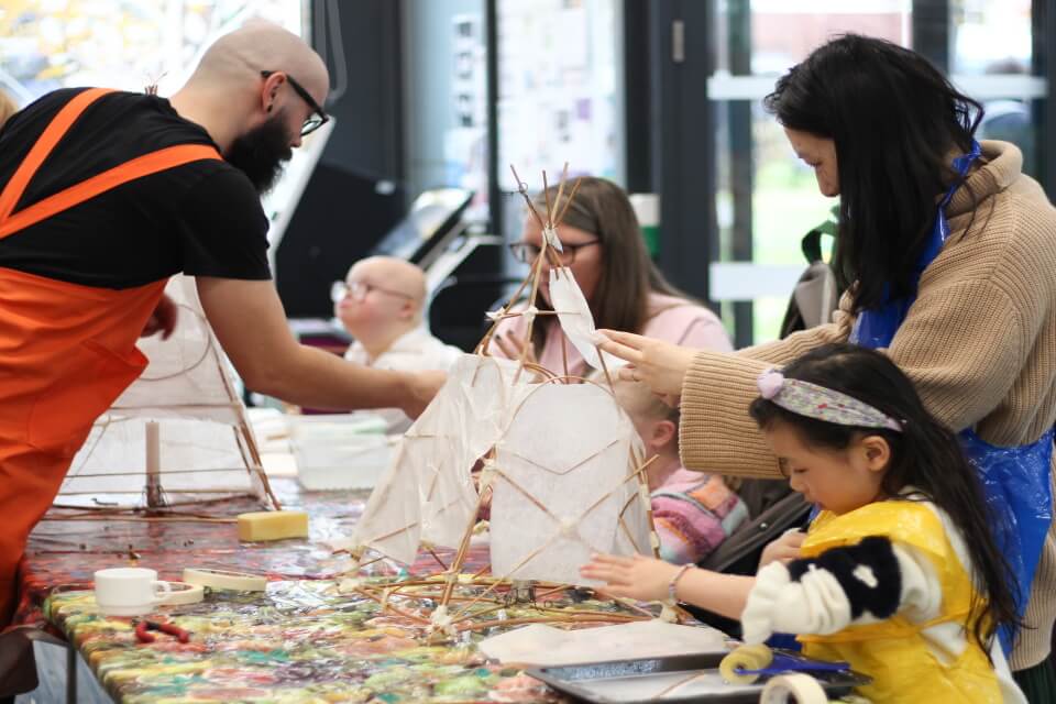 People making lanterns in a workshop environment